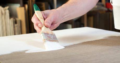 Apply sizing and/or gesso primer using a quality brush or paint roller